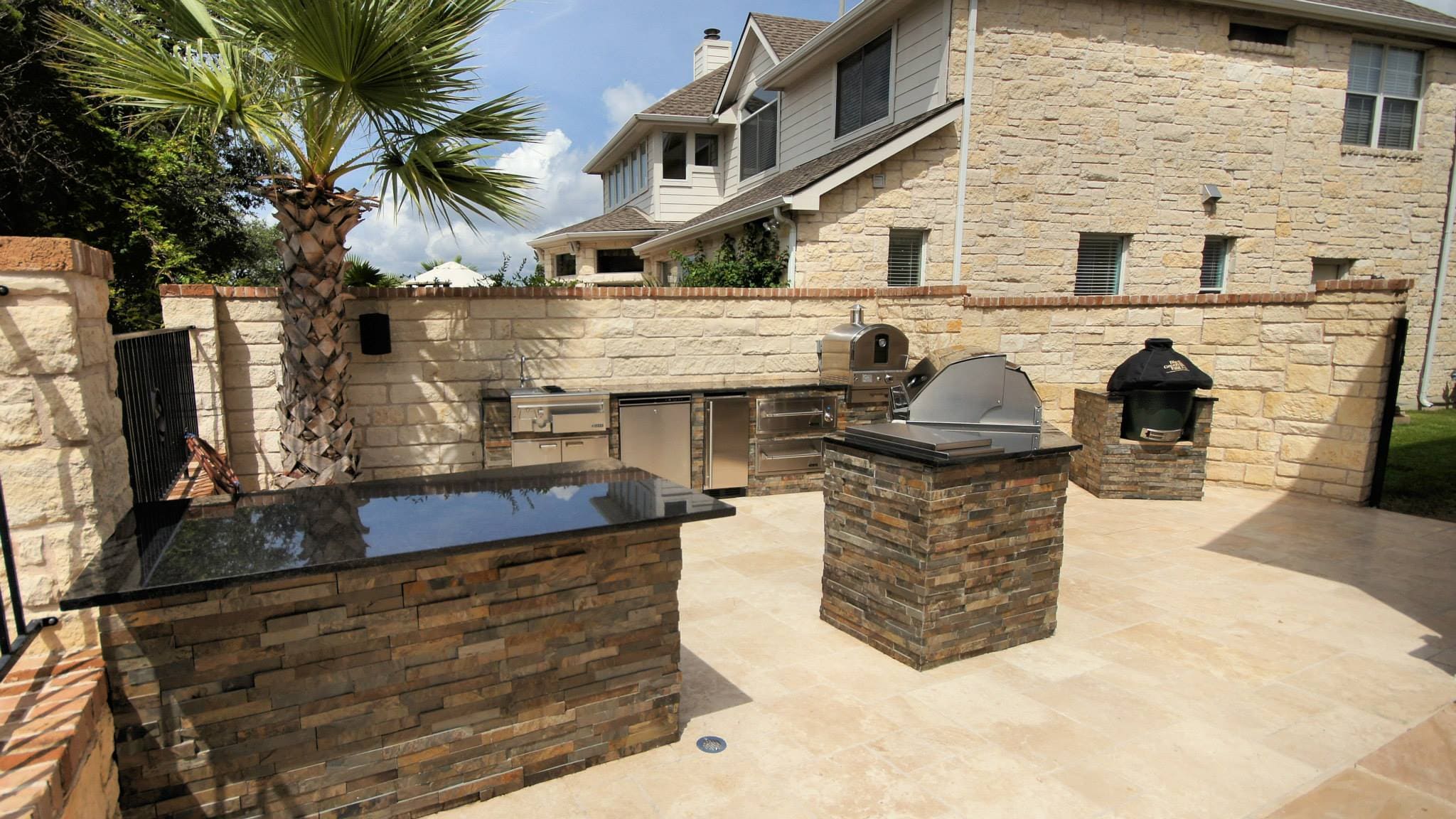 A large outdoor kitchen with an oven and grill.