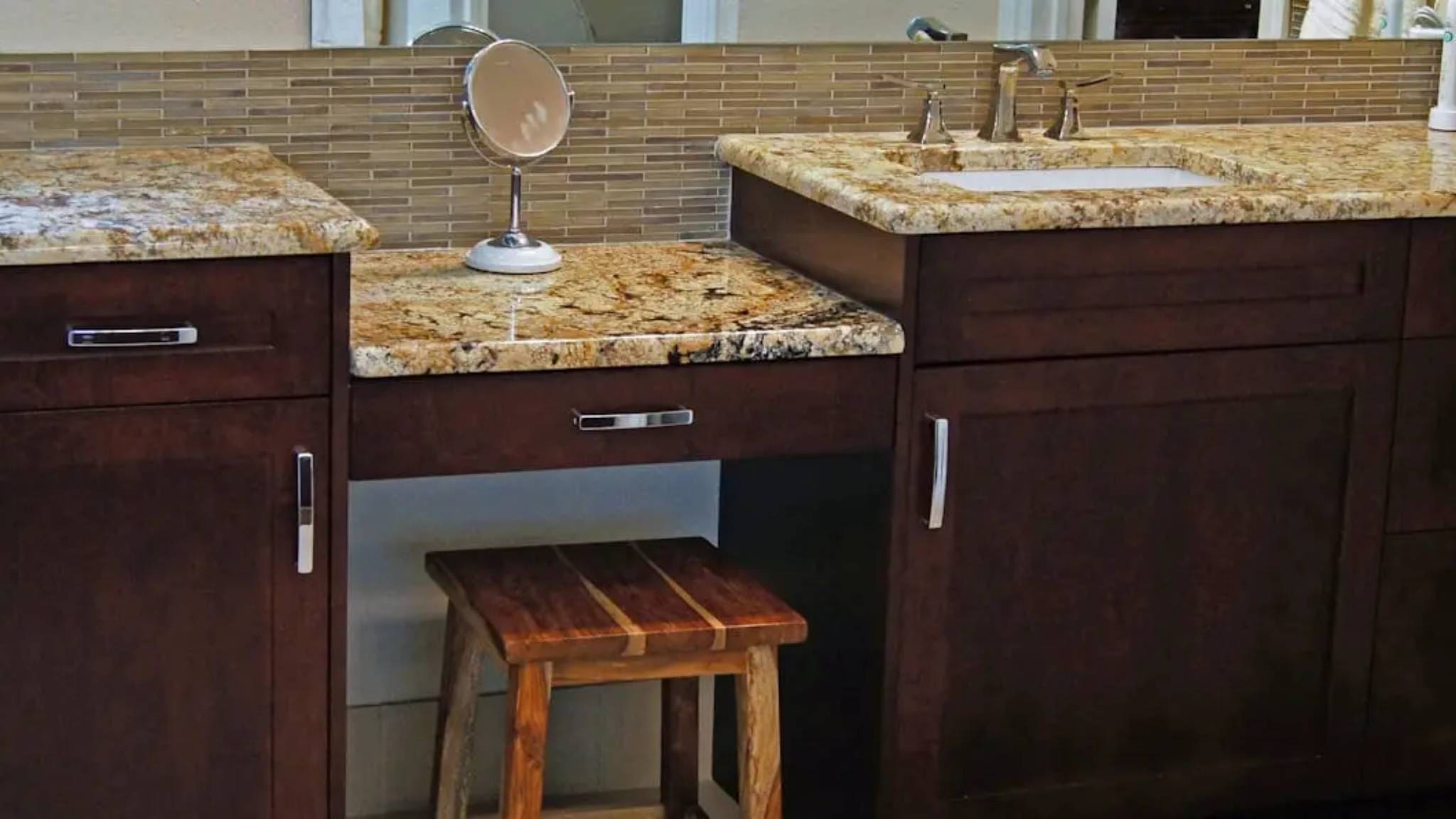 A bathroom with two sinks and a mirror.